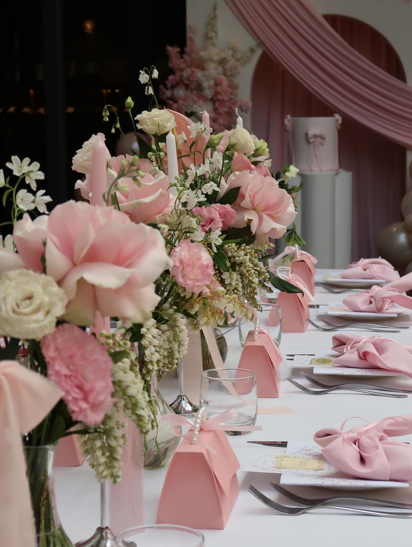 Soft blush florals styled across a tablescape