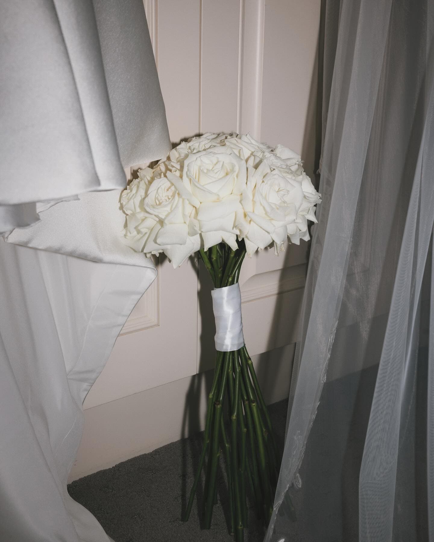 Long-stem white rose bridal bouquet, classic styling