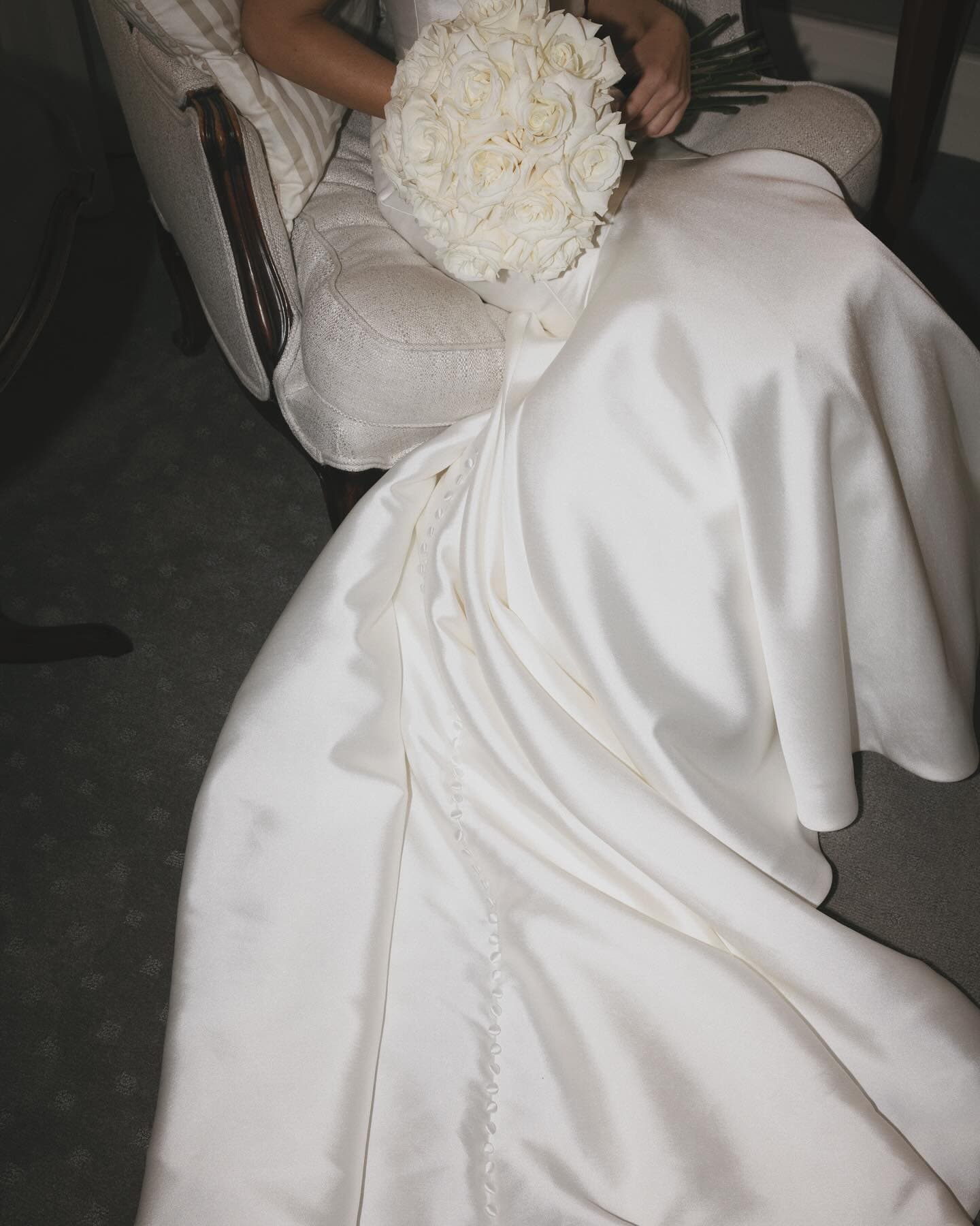 Bride holding white rose bouquet at Mandalay House and Garden