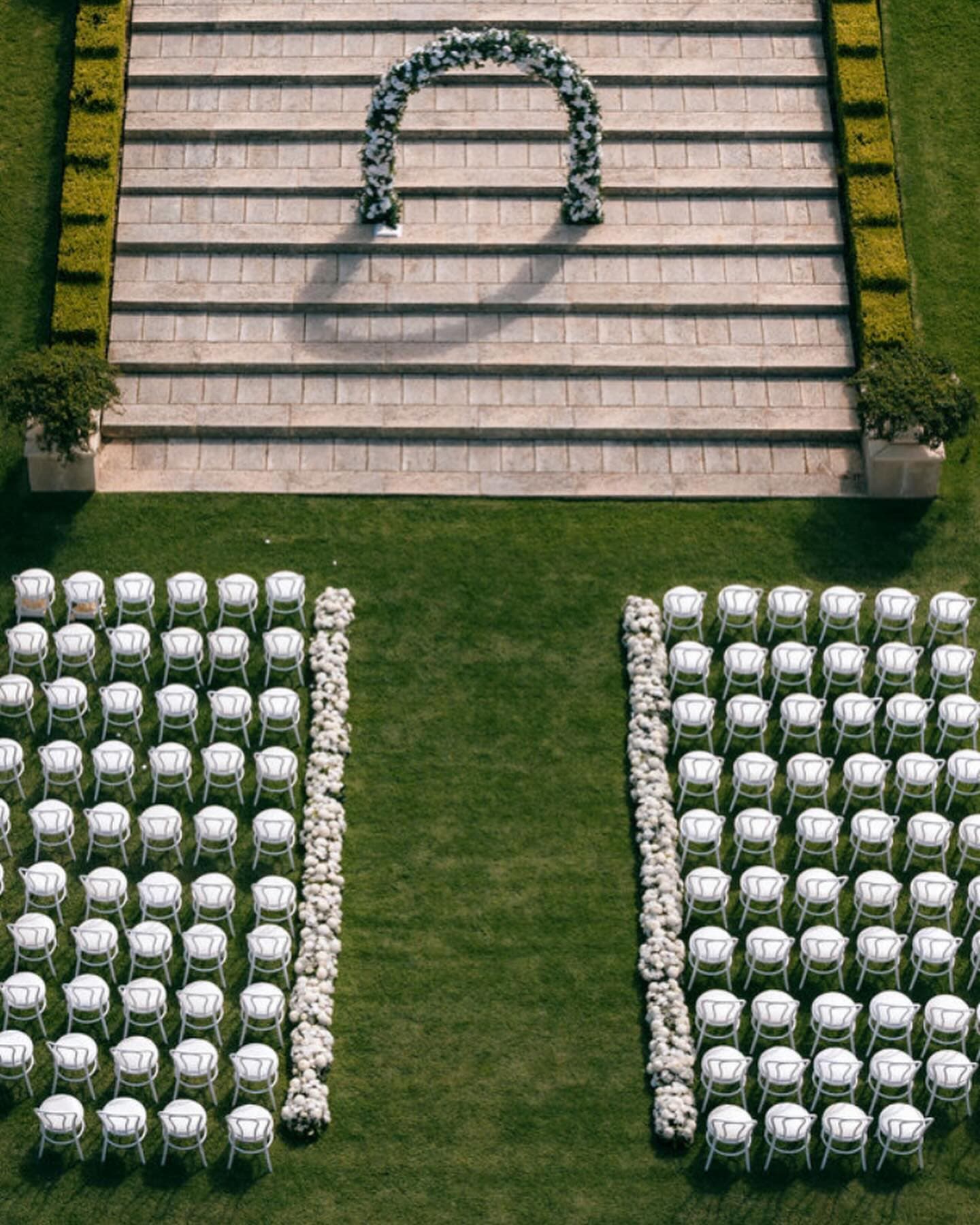 Ceremony setup at Mandalay with floral hedge along the aisle